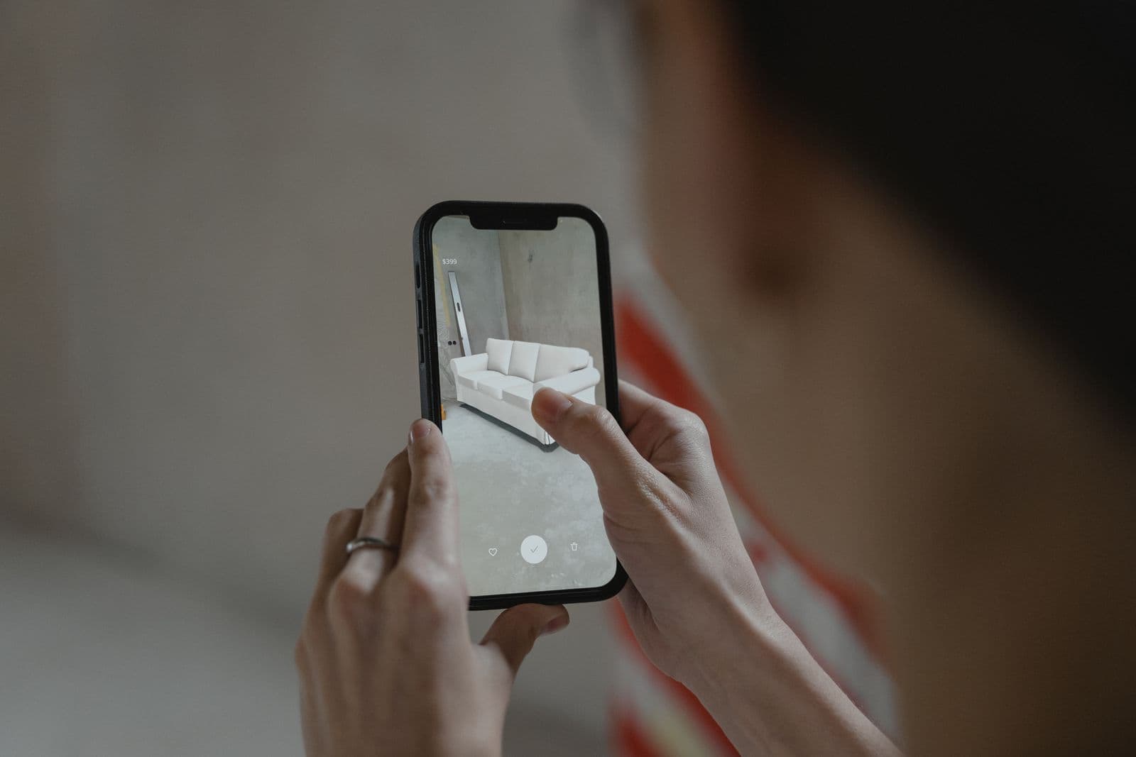 Guest holding a phone with a browser-based AR object placed in the room, no app download