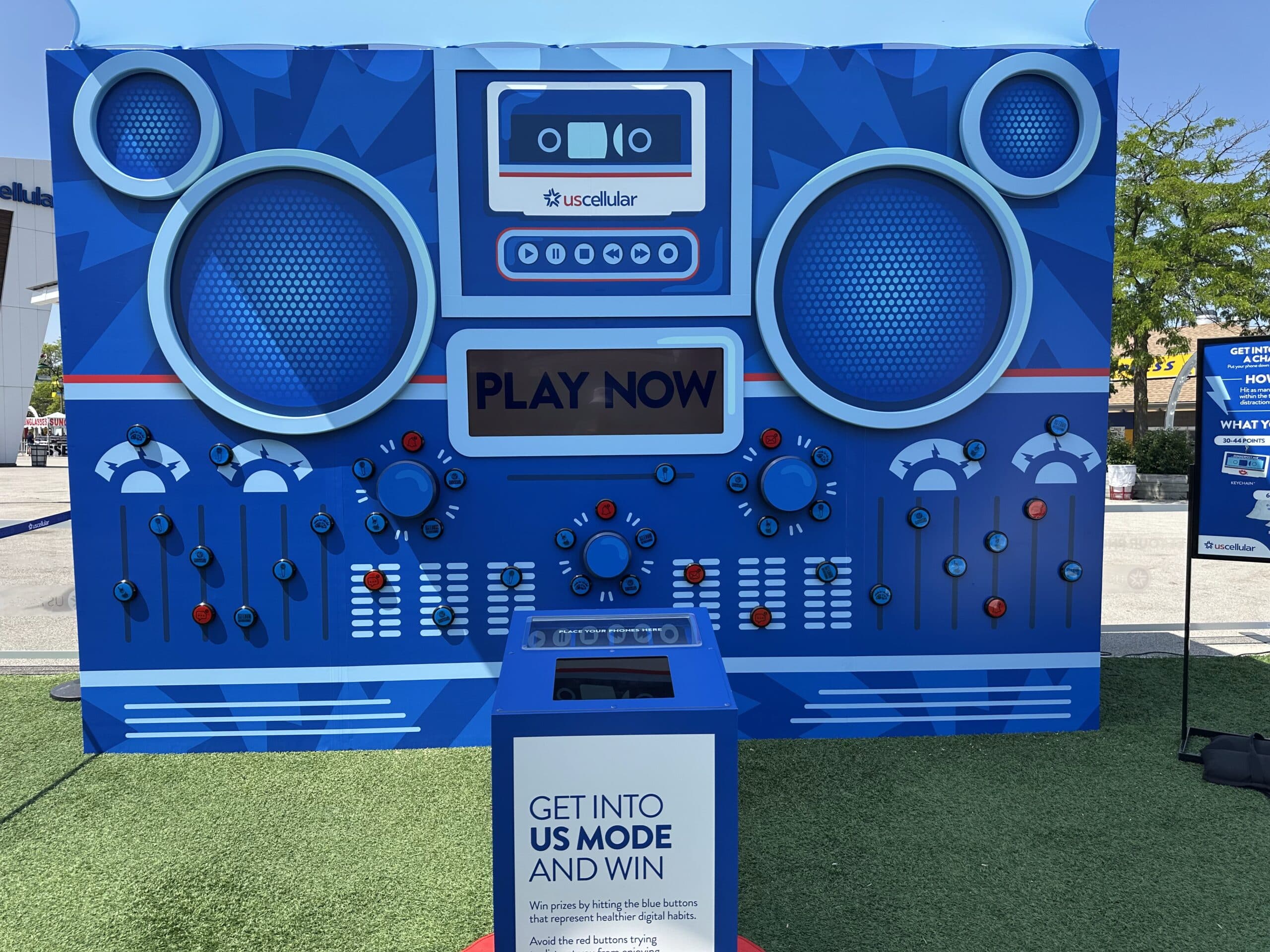 Festivalgoer playing the US Mode boombox arcade at Summerfest