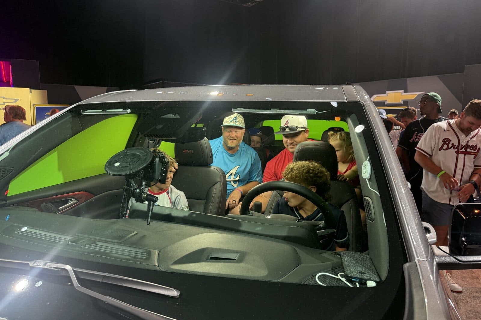 Guests inside a Chevy truck on the green-screen photo set at the 2025 MLB All-Star Game Fan Fest
